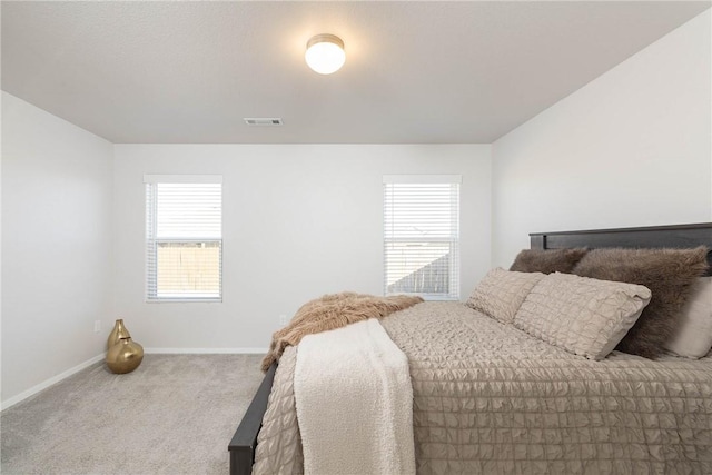 bedroom featuring visible vents, carpet floors, and baseboards