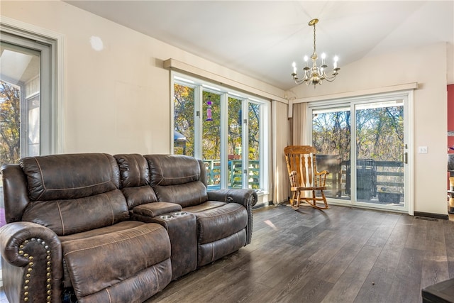 living room with a notable chandelier, plenty of natural light, dark wood-type flooring, and vaulted ceiling