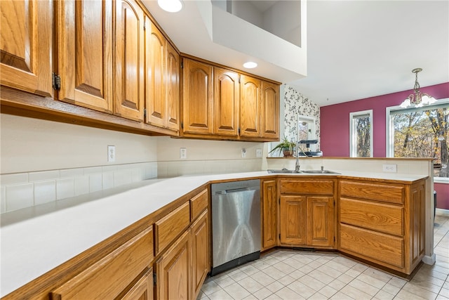 kitchen with an inviting chandelier, sink, hanging light fixtures, stainless steel dishwasher, and kitchen peninsula