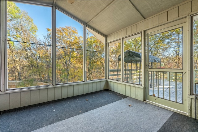 unfurnished sunroom with a wealth of natural light and vaulted ceiling