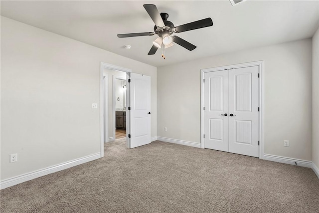 unfurnished bedroom featuring ceiling fan, light colored carpet, and a closet