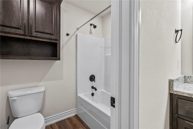 full bathroom featuring vanity, tub / shower combination, hardwood / wood-style floors, and toilet