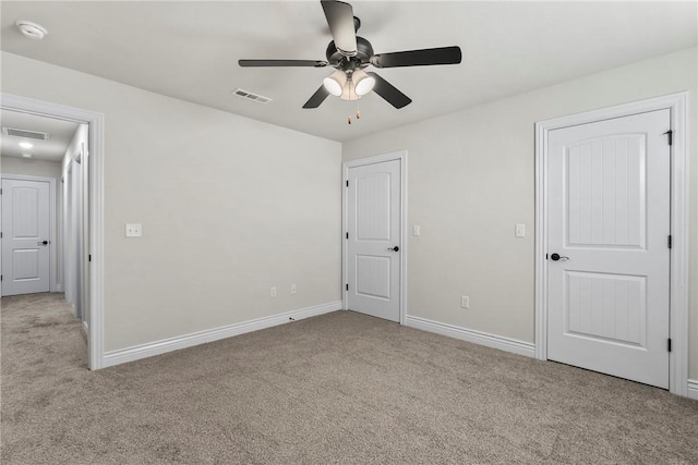 unfurnished bedroom with light colored carpet and ceiling fan