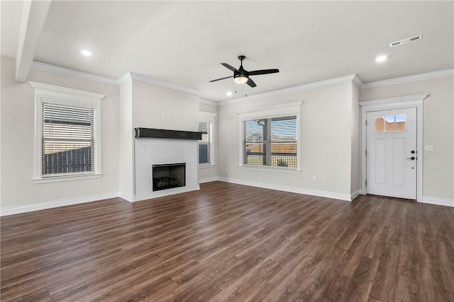 unfurnished living room featuring crown molding, dark wood-type flooring, a fireplace, and ceiling fan