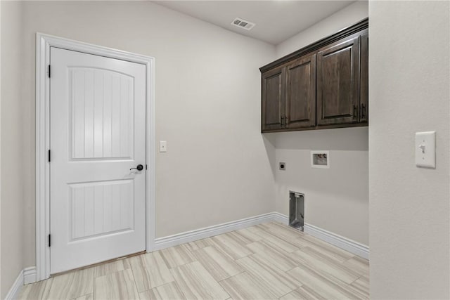 washroom featuring hookup for a washing machine, electric dryer hookup, and cabinets