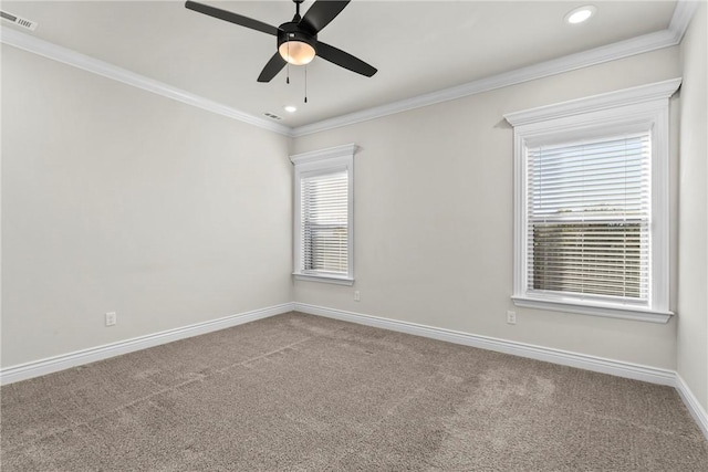 carpeted spare room featuring crown molding and ceiling fan