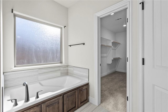 bathroom featuring a tub to relax in