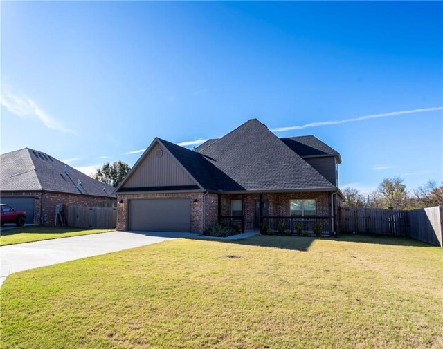 view of front of property with a front yard and a garage