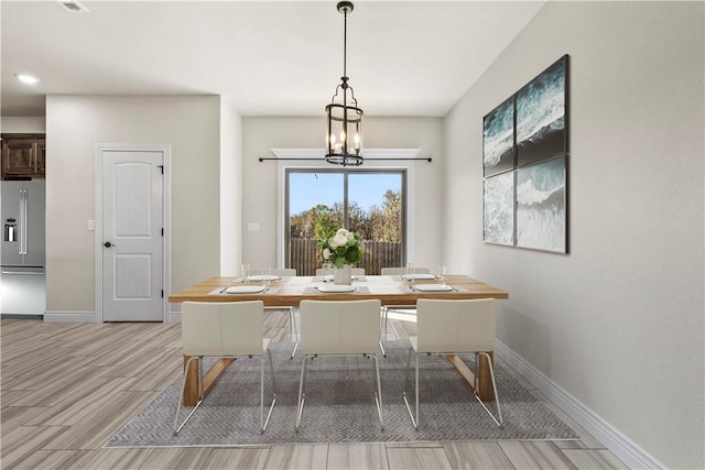 unfurnished dining area with a chandelier and light hardwood / wood-style floors