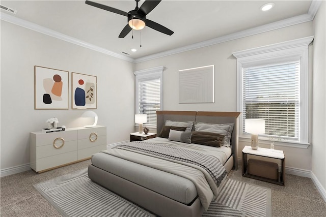 carpeted bedroom featuring crown molding and ceiling fan