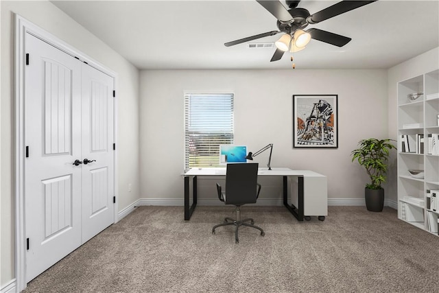 carpeted office featuring ceiling fan