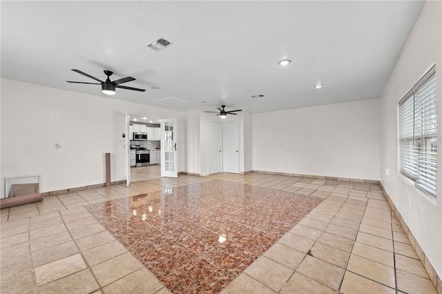 unfurnished living room with ceiling fan