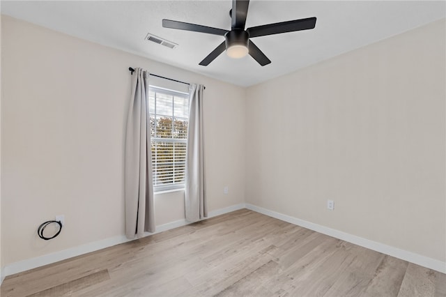 spare room featuring ceiling fan and light hardwood / wood-style flooring