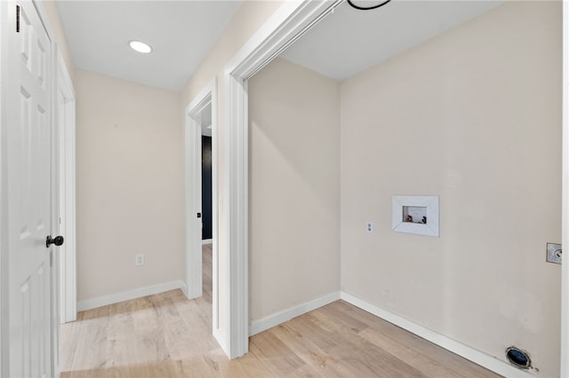 laundry room with electric dryer hookup, hookup for a washing machine, and light hardwood / wood-style floors