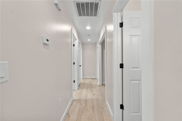 hall with light hardwood / wood-style floors