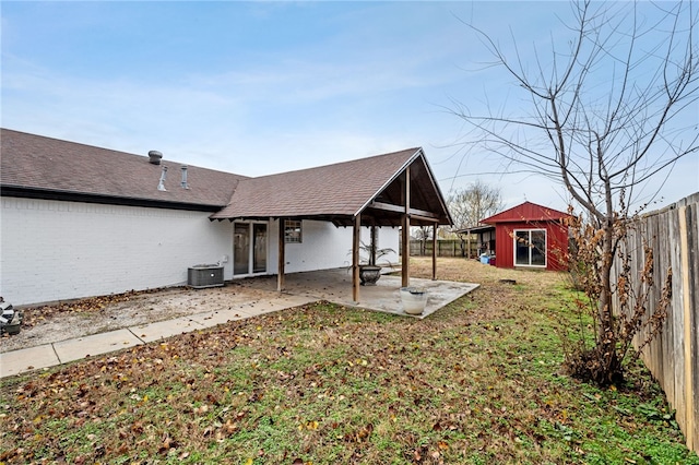 back of property featuring a patio area, an outdoor structure, and central air condition unit