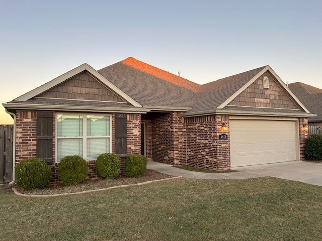 view of front of house with a garage and a lawn