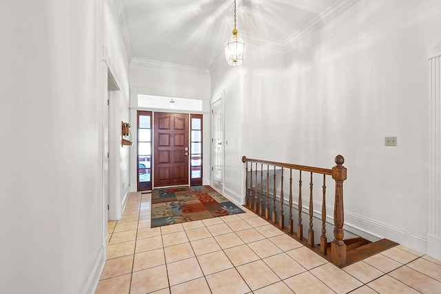 entrance foyer with crown molding, light tile patterned flooring, and a chandelier