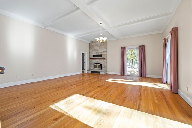 unfurnished living room featuring beamed ceiling, light wood-type flooring, a chandelier, and a fireplace