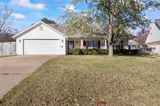 ranch-style house featuring a garage and a front lawn