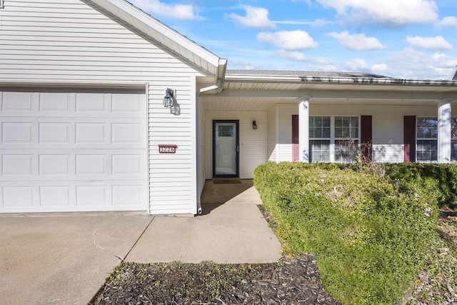 doorway to property with a garage