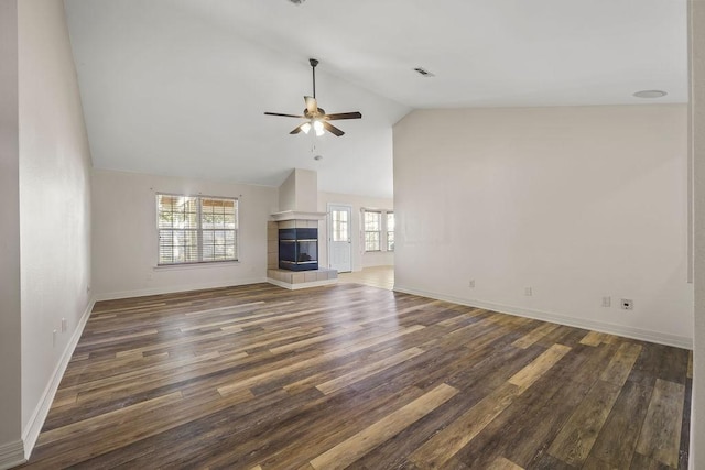 unfurnished living room featuring a tile fireplace, high vaulted ceiling, ceiling fan, and dark hardwood / wood-style flooring