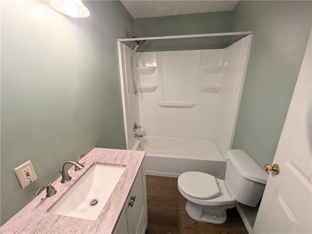 full bathroom featuring vanity, shower / tub combination, hardwood / wood-style flooring, toilet, and a textured ceiling