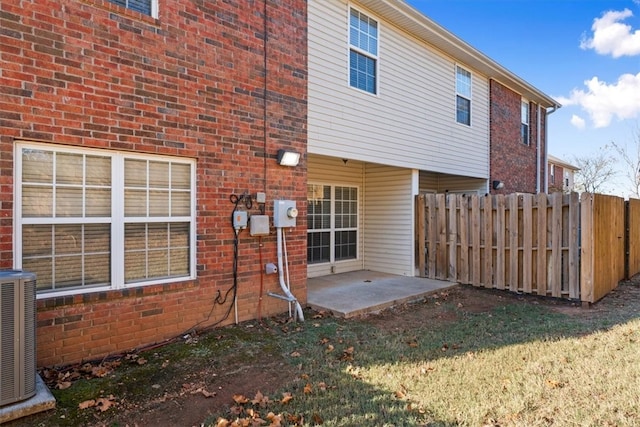 back of house featuring a patio, central AC, and a lawn