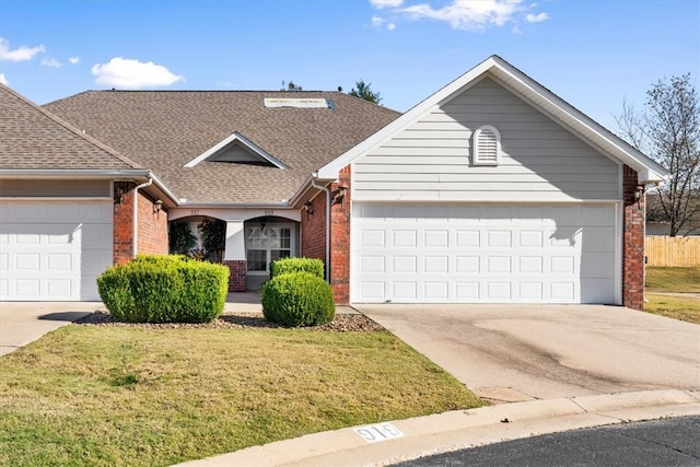 single story home featuring a front lawn and a garage