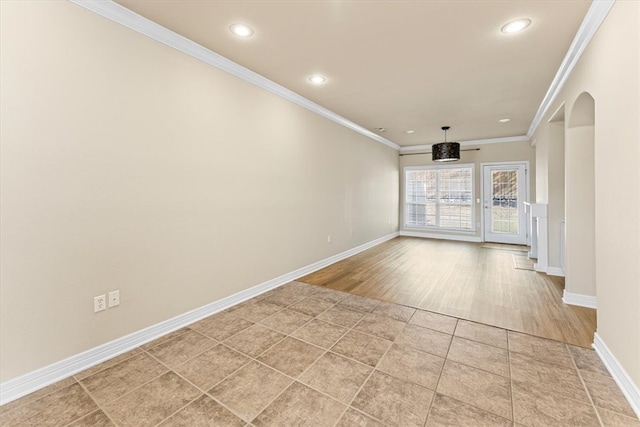 empty room with light hardwood / wood-style floors and ornamental molding