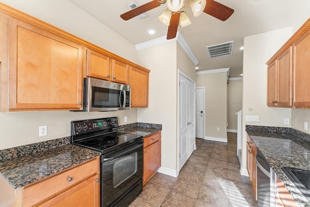 kitchen featuring ceiling fan, crown molding, dark stone counters, light tile patterned flooring, and appliances with stainless steel finishes