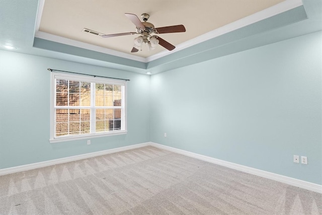 unfurnished room featuring ceiling fan, a raised ceiling, and carpet floors