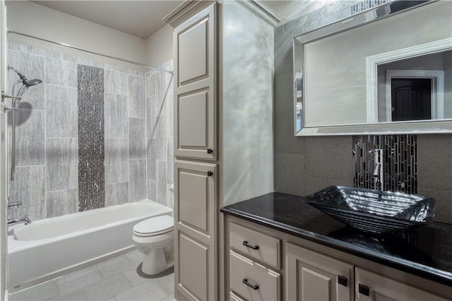 full bath with decorative backsplash, toilet, vanity, shower / tub combination, and tile patterned floors