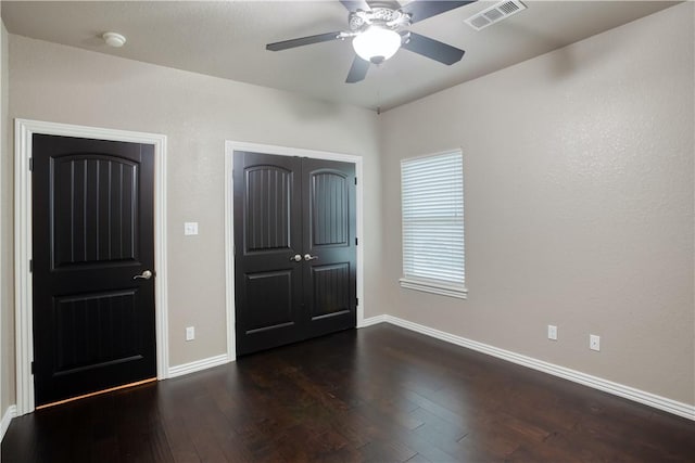 interior space with hardwood / wood-style floors, a closet, visible vents, and baseboards