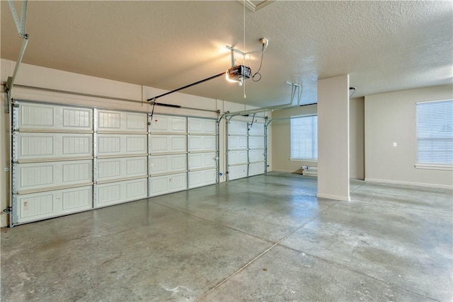 garage with a garage door opener and baseboards