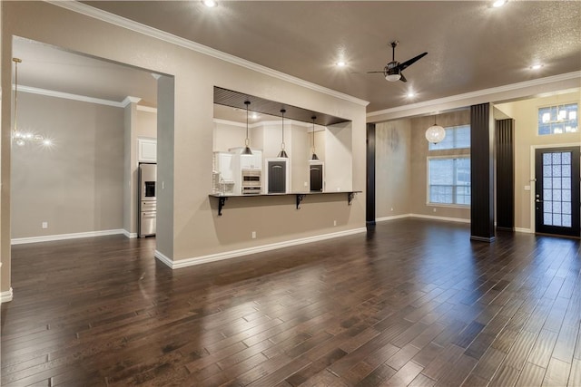 living room featuring dark wood-style floors, ornamental molding, baseboards, and a ceiling fan