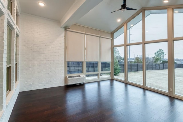 interior space with beamed ceiling, a wall of windows, wood finished floors, and a wall mounted air conditioner