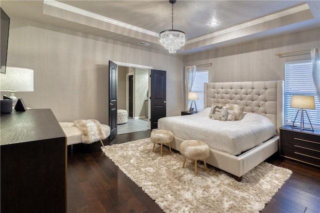 bedroom with dark wood-style floors, a tray ceiling, and ornamental molding