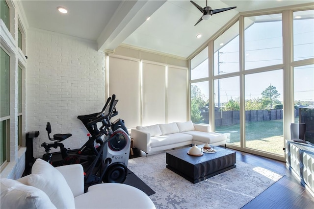 sunroom / solarium featuring vaulted ceiling with beams and ceiling fan