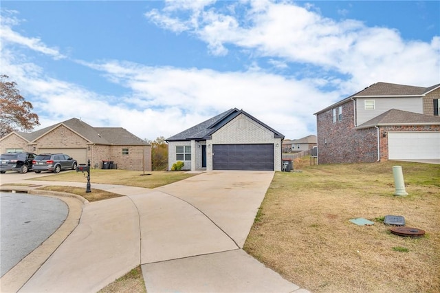 view of front of house with a garage and a front lawn