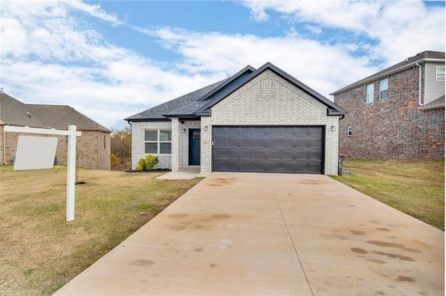 view of front of home with a garage and a front lawn