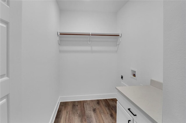 clothes washing area featuring washer hookup, electric dryer hookup, cabinets, and hardwood / wood-style flooring