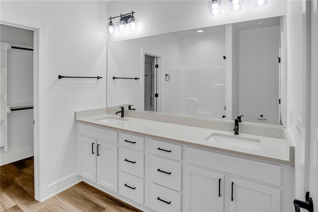 bathroom with hardwood / wood-style flooring and vanity