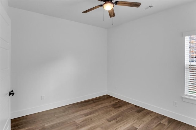 empty room with ceiling fan and hardwood / wood-style flooring