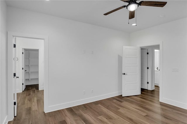 unfurnished room featuring hardwood / wood-style floors and ceiling fan