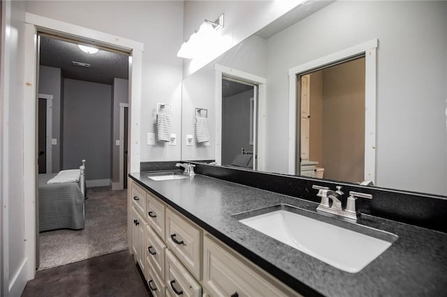 bathroom with vanity, toilet, and a textured ceiling