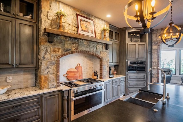 kitchen with dark brown cabinetry, stainless steel appliances, sink, and backsplash