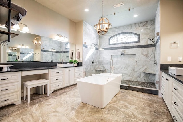 bathroom featuring an inviting chandelier, vanity, and independent shower and bath