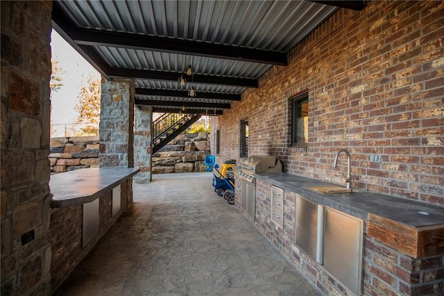 view of patio featuring area for grilling, a grill, and sink