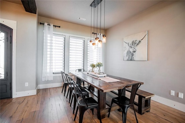 dining space featuring light wood-type flooring